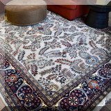 D03. Ivory and navy handknotted Persian rug. Approx. 8'9” x 12'3” 